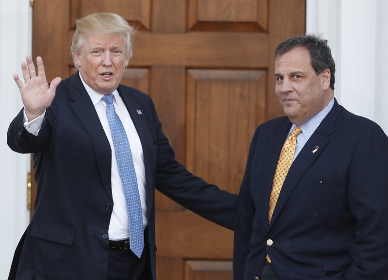 FILE - In this Nov. 20, 2016 file photo, then President-elect Donald Trump, left, waves to the media as New Jersey Gov. Chris Christie arrives at the Trump National Golf Club Bedminster clubhouse, in Bedminster, N.J. After being unceremoniously dropped from President Donald Trump's transition team, New Jersey Gov. Chris Christie is dipping his toes into the administration as he takes the lead of a White House commission to combat opioid addiction. (AP Photo/Carolyn Kaster, File)