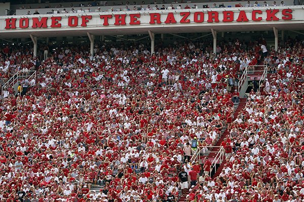 In this Sept. 5, 2015, file photo, Arkansas fans cheer on the Hogs during an NCAA college football game against UTEP at Donald W. Reynolds Razorback Stadium in Fayetteville, Ark. The Southeastern Conference said Tuesday, March 28, 2017, it wants Arkansas lawmakers to exempt college sporting events such as football games from a new law greatly expanding where concealed handguns are allowed, citing concerns about safety at its games. (AP Photo/Samantha Baker, File)