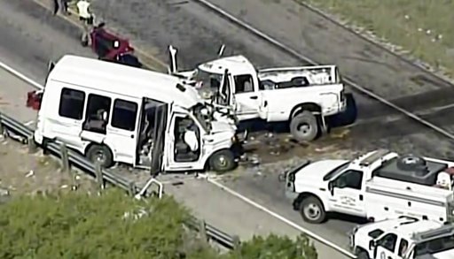 In this aerial image made from a video provided by KABB/WOAI, authorities respond to a deadly crash involving a van carrying church members and a pickup on U.S. 83 outside Garner State Park in northern Uvalde County, Texas, on Wednesday, March 29, 2017.