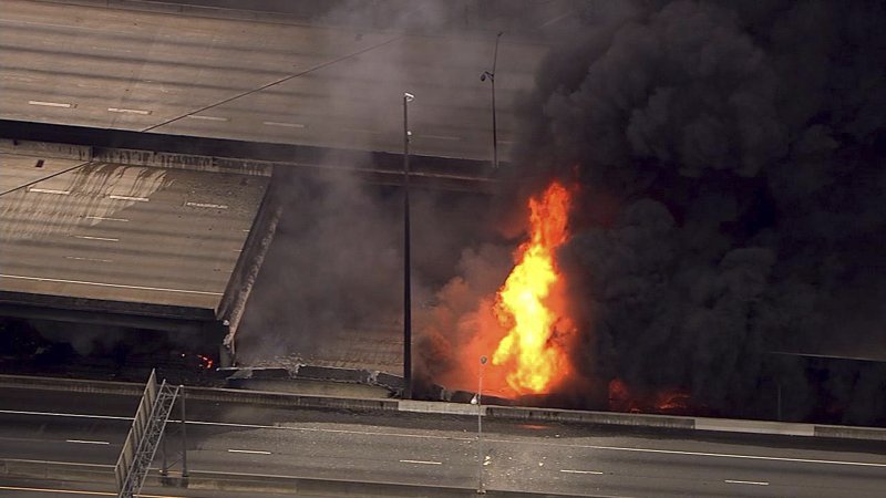 In this aerial image made from a video provided by WSB-TV, a large fire that caused an overpass on Interstate 85 to collapse burns in Atlanta, Thursday, March 30, 2017. Witnesses say troopers were telling cars to turn around on the bridge because they were concerned about its integrity. Minutes later, the bridge collapsed. (WSB-TV via AP)