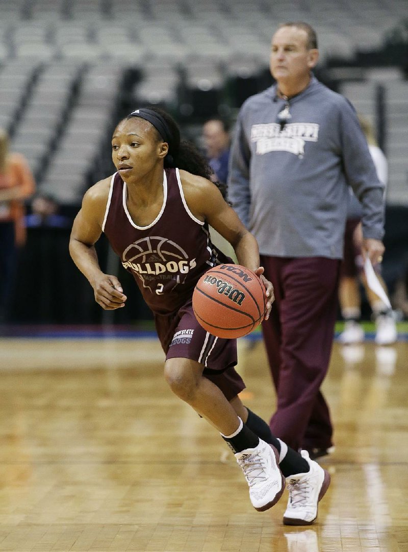 Mississippi State Coach Vic Schaefer (right) watches guard Morgan William head toward the floor during a practice session Thursday in preparation for today’s NCAA Women’s Tournament Final Four game against Connecticut. When the teams met in last season’s Sweet 16, the Huskies, who are in the national semifi nals for the 10th consecutive year, beat the Bulldogs 98-38.