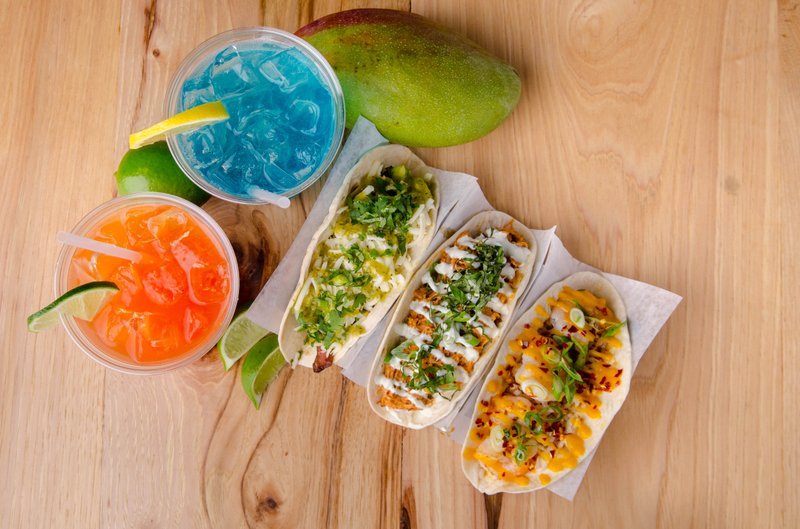 The Con Quesos menu features globally inspired tacos and cheese dip options.