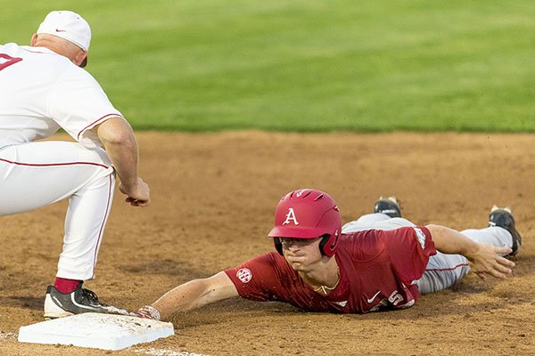 Arkansas's Jared Gates (3) dives back to first in time as Alabama infielder Cody Henry (9) looks to pick him off during an NCAA college baseball game, Friday, March 31, 2017, at Sewell–Thomas Stadium in Tuscaloosa, Ala. (Vasha Hunt/AL.com via AP)

