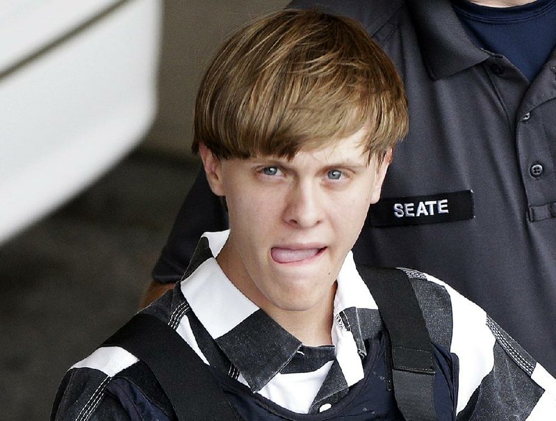 In this June 18, 2015, file photo, Charleston, S.C., shooting suspect Dylann Storm Roof is escorted from the Cleveland County Courthouse in Shelby, N.C.   