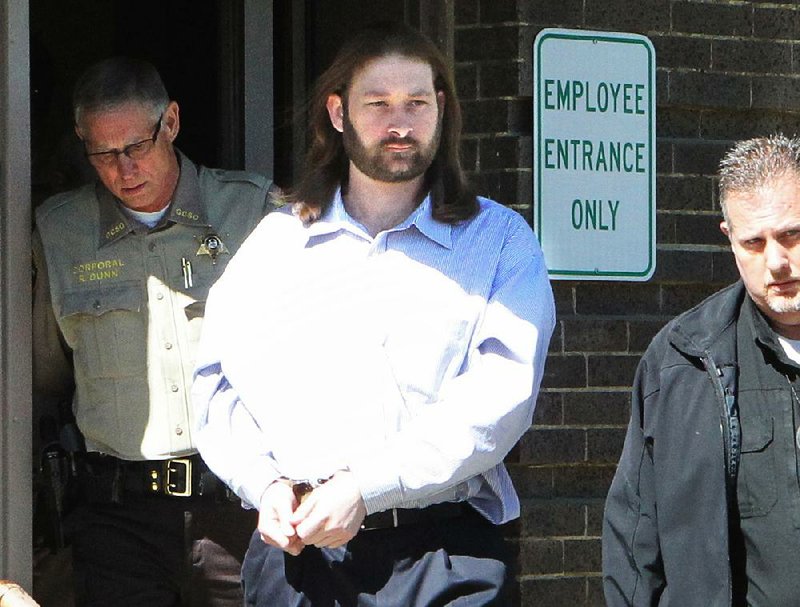 Kevin Duck leaves the Garland County Courthouse under guard Friday after he was sentenced to life in prison for the 2011 slaying of Dawna Natzke.