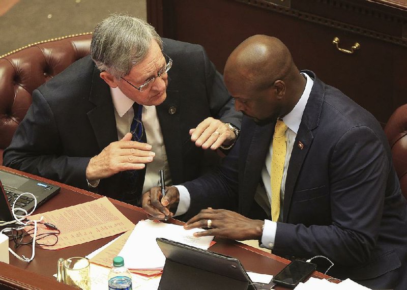 FILE - Rep. Jack Ladyman (left) talks with Rep. Monte Hodges about Senate Bill 688, which would provide tax credits to businesses. The bill was approved by the House.