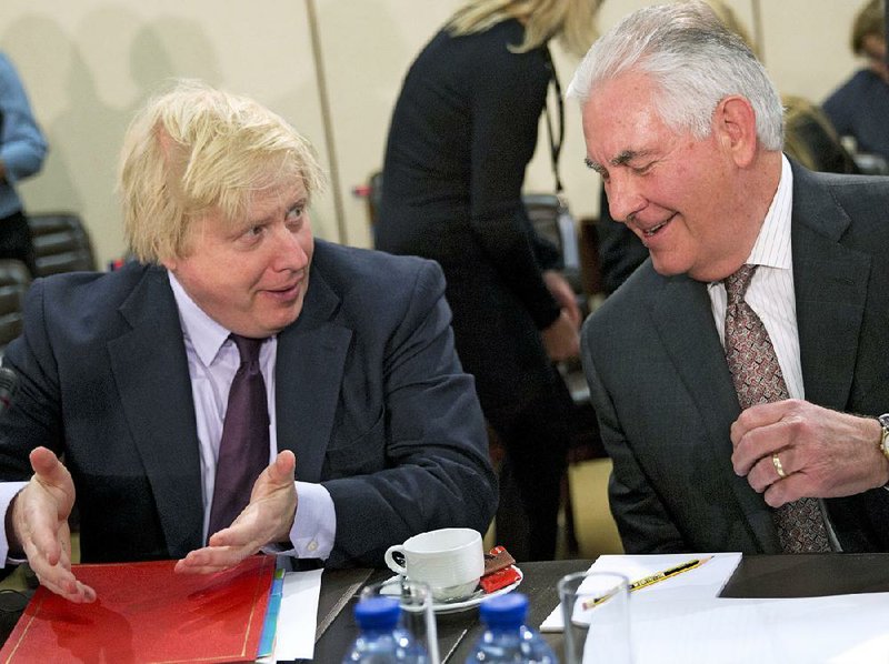 British Foreign Secretary Boris Johnson (left) talks Friday with Secretary of State Rex Tillerson at a meeting of NATO foreign ministers in Brussels. Tillerson insisted other members must increase defense spending, but he still pledged to defend U.S. allies, saying, “We understand that a threat against one of us is a threat against all of us.”