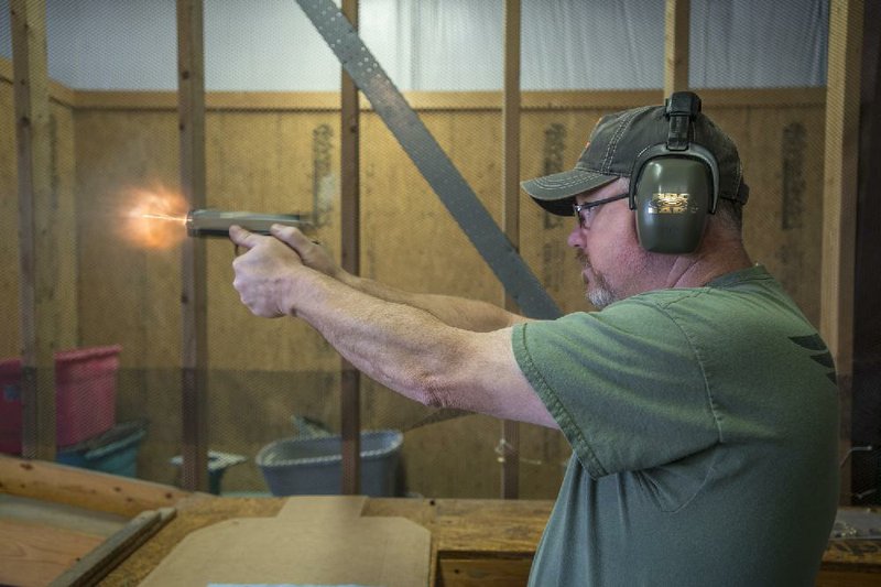 Greg Martin with Wilson Combat fires an EDC X9 at the company’s headquarters in Berryville. Martin is in charge of final inspection of all weapons made by the company. 