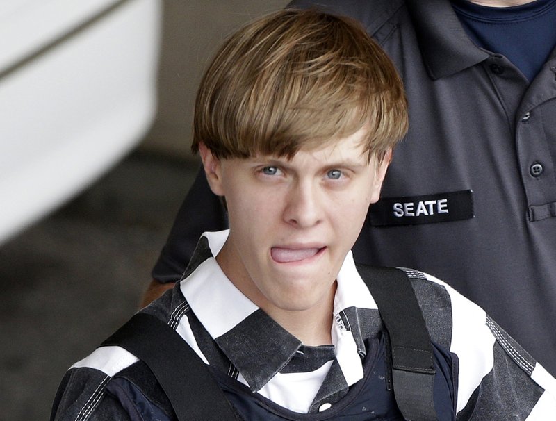 FILE - In this June 18, 2015, file photo, Charleston, S.C., shooting suspect Dylann Storm Roof is escorted from the Cleveland County Courthouse in Shelby, N.C.  Solicitor Scarlett Wilson told The Associated Press on Friday, March 31, 2017, that Roof is scheduled to enter a guilty plea during a hearing on April 10 in Charleston. The plea on all of his state charges, including nine counts of murder, comes in exchange for a sentence of life in prison, the prosecutor said. Roof has been awaiting trial on state murder charges for the deaths of nine black parishioners at Charleston's Emanuel AME Church in June 2015. (AP Photo/Chuck Burton, File)