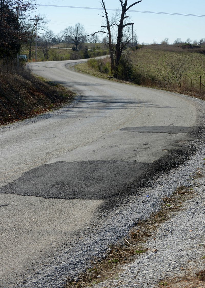 Patches can be seen in the pavement Feb. 24 along Stoney Point Road in eastern Benton County. GreenbergFarrow Architecture surveyed paved roads in the county and justices of the peace will look at a video survey and assessment of roads when the Transportation Committee meets Tuesday.