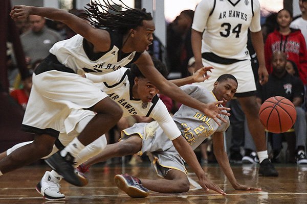 Arkansas Hawks players Ja'Mon Smith, left, and Desi Sills, center, along with Dallas Pacers' Jordan Massenburg scramble for a loose ball during the first round in the Real Deal in the Rock Tournament at P.A.R.K. Friday, March 31, 2017, in Little Rock.