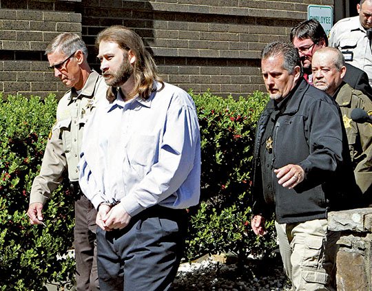 The Sentinel-Record/Richard Rasmussen TRIAL ENDS: Kevin Duck, second from left, is escorted from the Garland County Court House on Friday after a jury found him guilty of first-degree murder for the December 2011 death of his girlfriend, Dawna Natzke, and sentenced him to life in prison.