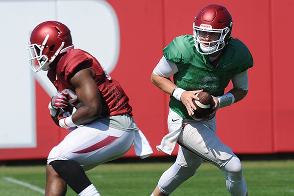 Arkansas quarterback Austin Allen rolls out to pass Saturday, April 1, 2017, during practice at the university practice field in Fayetteville. 