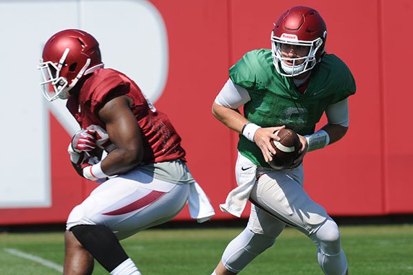 Arkansas quarterback Austin Allen rolls out to pass Saturday, April 1, 2017, during practice at the university practice field in Fayetteville. Arkansas quarterback Austin Allen rolls out to pass Saturday, April 1, 2017, during practice at the university practice field in Fayetteville.
