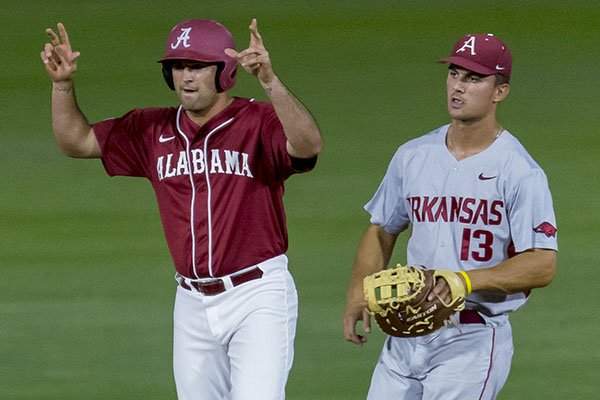 Alabama's Hunter Alexander (22) signals a double against Arkansas during an NCAA college baseball game Saturday, April 1, 2017, in Tuscaloosa, Ala. (Vasha Hunt/AL.com via AP)

