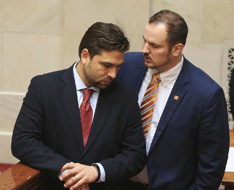 Senate President Pro Tempore Jonathan Dismang (left) talks with Sen. Trent Garner after Garner spoke against Dismang’s gun bill Friday on the Senate floor. Saying the right to carry a gun is “God-given,” Garner urged senators to “let law-abiding citizens protect themselves.”