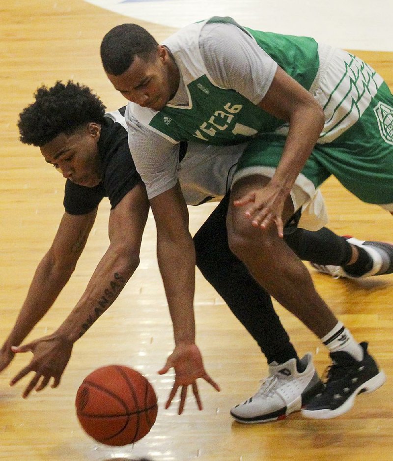 Arkansas Hawks guard Desi Sills (left) and Marcus Smart forward Kyler Edwards battle for a loose ball during the Real Deal in the Rock’s 17-Under championship game Sunday at P.A.R.K. in Little Rock. Marcus Smart won the game 73-72.