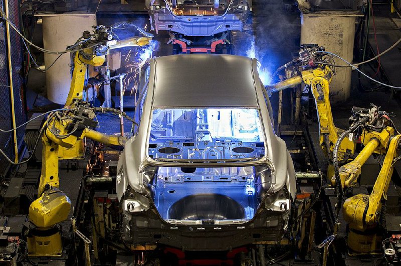 Robotic welders work on the bodies of 2016 Nissan Motor Co. Altima midsize vehicles at the company’s plant in Canton, Miss., in September.
