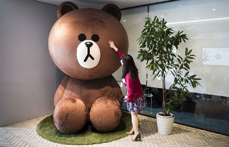An employee touches a Line Corp. character at the offices of Line Fukuoka Corp., a subsidiary of Line Corp., in Fukuoka, Japan, early last month.