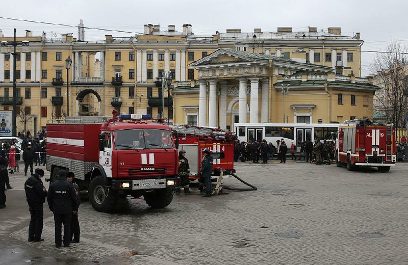 Russian police and emergency workers stand Monday near firetrucks at Sadovaya square in St. Petersburg.