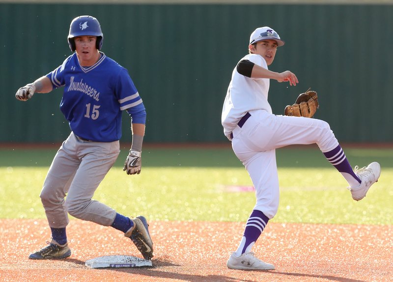 Rogers High School’s Grayson Lee is forced out as Fayetteville High School second baseman Quin Rudzinski follows through as he turns a double play during the seventh inning.