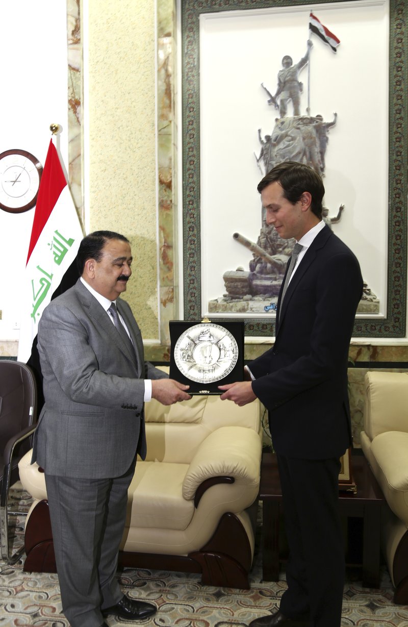 Jared Kushner, US President Donald Trump's son-in-law and senior adviser, right, receives a gift from Iraqi Defense Minister, Ifran al-Hayali, at the Ministry of Defense, Baghdad, Iraq, Monday, April 3, 2017. 