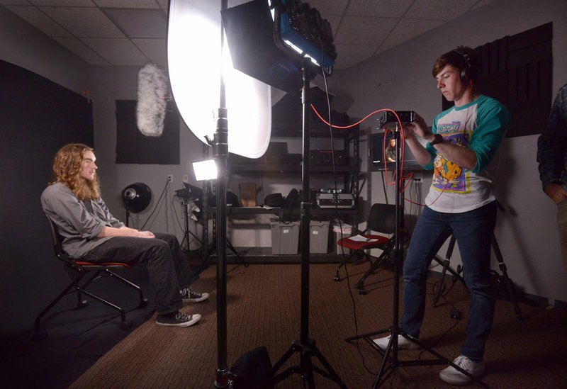 Devin Arnone (right) sets sets up an interview Monday with Carter Davis, both Bentonville High School seniors, during the Ignite program’s creative arts video production class at the University of Arkansas’ Global Campus in Rogers. story.lead_photo.caption