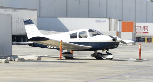 A small airplane sits in a warehouse parking lot April 4, 2017, in Whittier, Calif., the day after the pilot, Darrell Roberts, made an emergency landing.