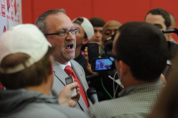 Arkansas women's basketball coach Mike Neighbors (left) speaks Tuesday, April 4, 2017, with members of the media during a ceremony and press conference to announce his hire at the university's basketball practice facility. 