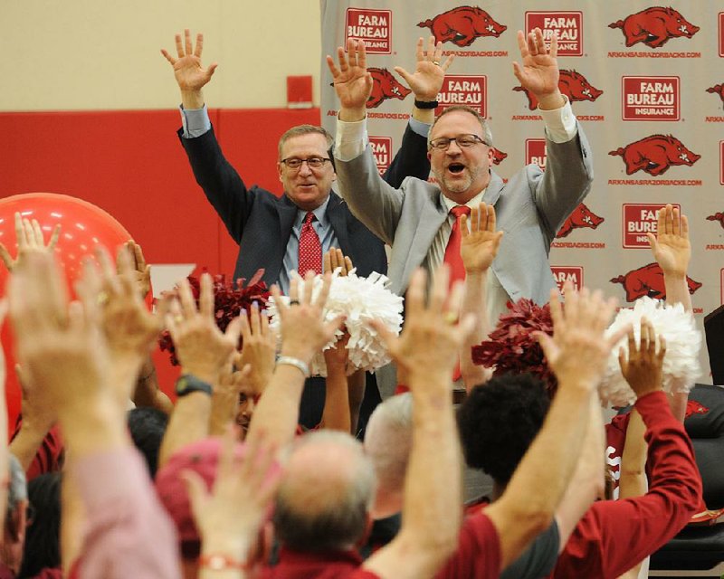 NWA Democrat-Gazette/ANDY SHUPE
Newly hired Arkansas women's basketball coach Mike Neighbors (right) leads the room Tuesday, April 4, 2017, in a Hog call alongside Jeff Long, director of athletics, during a ceremony and press conference to announce his hire at the university's basketball practice facility. Visit nwadg.com/photos to see more photographs from the event.