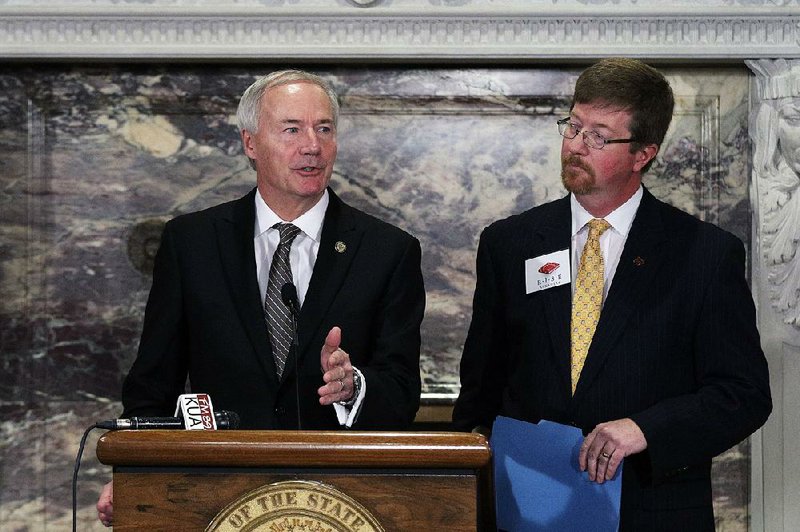 Governor Asa Hutchinson, left, speaks as Commissioner of Education Johnny Key looks on during the R.I.S.E. (Reading Initiative for Student Excellence) Arkansas initiative press conference at the Capitol Thursday, January 26, 2017.