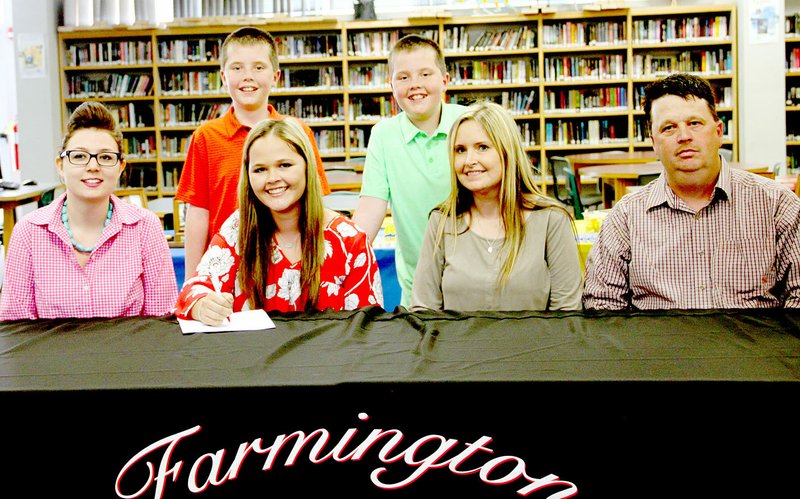 LYNN KUTTER ENTERPRISE-LEADER Jessika Calhoon, a senior at Farmington High School, signed a letter of intent last week for the livestock judging team at Eastern Oklahoma State College in Wilburton, Okla. She is pictured with Eastern coach Jade Jenkins, left, her parents John and Julie Calhoon and her twin brothers, Jason and Justin.