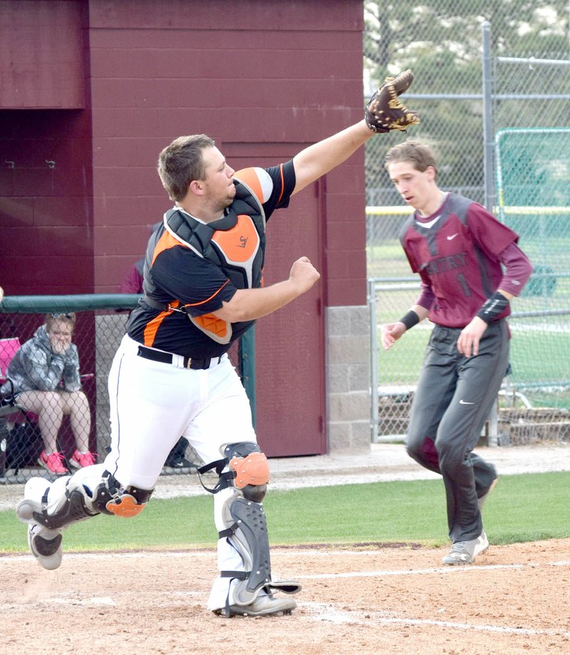 Photo by Mike Eckels Gravette catcher Kenton Tajchman waits for the ball as Gentry&#8217;s Colton Little heads for home plate during the March 28 Gravette-Gentry varsity baseball contest in Gentry. Little managed to cross the plate for Gentry&#8217;s fourth run.