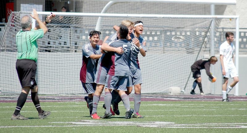 Graham Thomas/Herald-Leader Siloam Springs boys soccer players, from left, Jose Serrano, Jack Bos, Aric Lee and Christian Marroquin celebrate after Bos scored with 2:37 left in the match to give the Panthers a 2-1 victory over Holland Hall (Okla.) on Saturday in the semifinals of the Panther Classic.