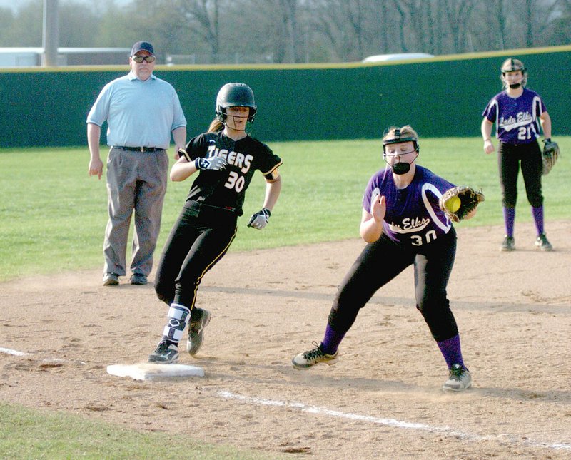 MARK HUMPHREY/ENTERPRISE-LEADER/Opposite No. 30s. Prairie Grove junior Madison Vinson arrives safely on base while Elkins third baseman Lakyn Whelpey receives a throw. The Lady Tigers won by a 13-3 run-rule score at home March 28.