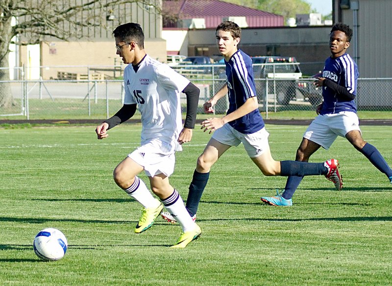 Photo by Randy Moll Eiji Furumori, Gentry senior, moved the ball past his Subiaco defenders and toward the goal on Friday, March 31, in Gentry.