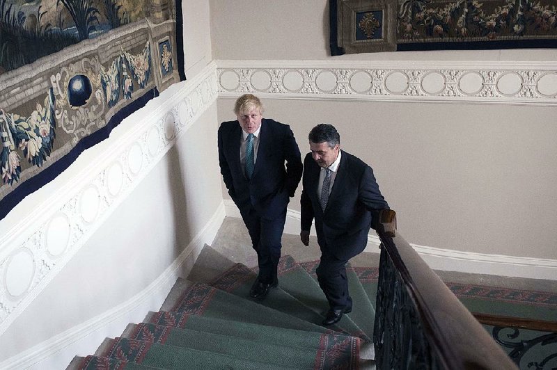 Britain’s Foreign Secretary Boris Johnson (left) and German Foreign Minister Sigmar Gabriel meet Tuesday in London. Gabriel said the U.K. likely will suffer if it exits the European Union without a trade deal in place.