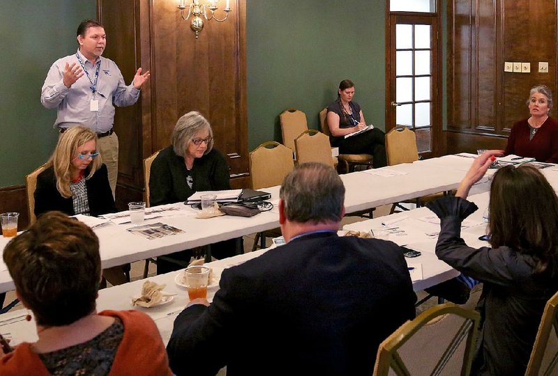 Jamie Collins (standing) of the Little Rock Department of Public Works provides an update on Phase II of the city’s Main Street redesign project during a Wednesday meeting of a committee of the Little Rock Downtown Partnership.