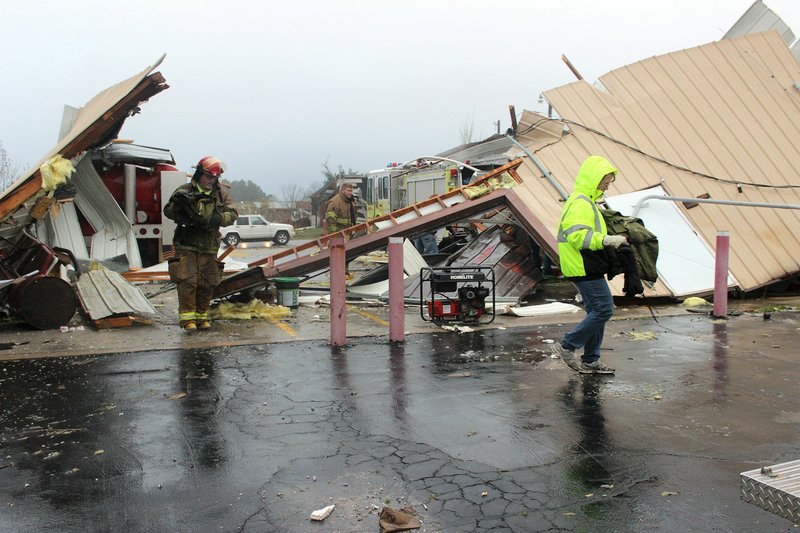 Volunteer firefighters with the Goodman, Mo., Fire Department remove equipment Wednesday from what remains of Goodman’s department following a Tuesday evening tornado that ripped through the McDonald County town.