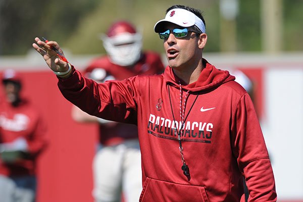 Arkansas offensive coordinator Dan Enos directs his players Saturday, April 1, 2017, during practice at the university practice field in Fayetteville.