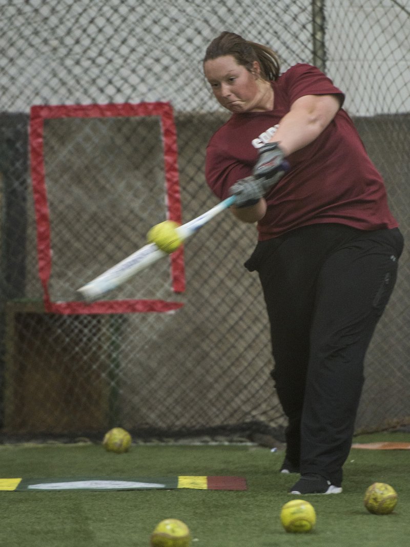 Springdale High senior third baseman Whitnee Patterson takes batting practice Wednesday at the Springdale indoor practice facility. 