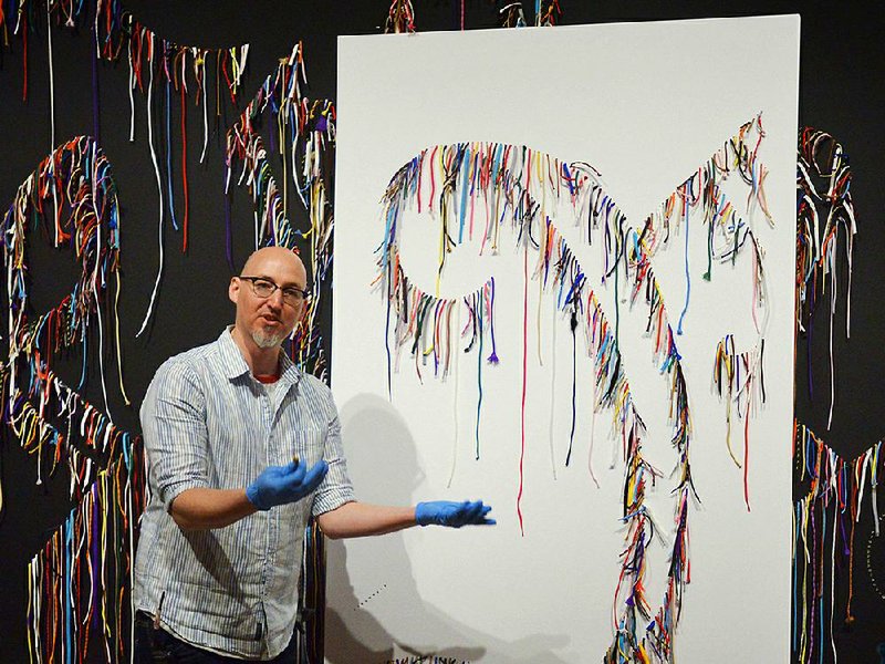 Kevin Haynie, an art preparator at Crystal Bridges Museum of American Art, explains the installation process of Nari Ward’s wall sculpture We the People. The installation is made of shoelaces that spell out the first three words of the preamble to the U.S. Constitution.