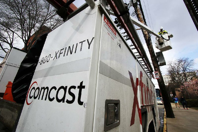 A Comcast lineman works in Pittsburgh in March. Comcast on Thursday announced plans to offer wireless phone service on a network it will lease from Verizon. 
