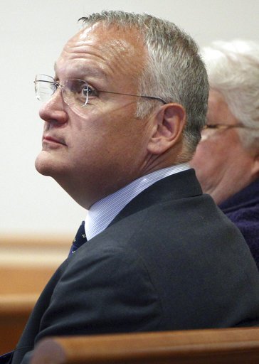 FILE - In this April 23, 2014, file photo, Monsignor Edward Arsenault looks back before pleading guilty to three felony theft charges in Hillsborough County superior court in Manchester, N.H. 