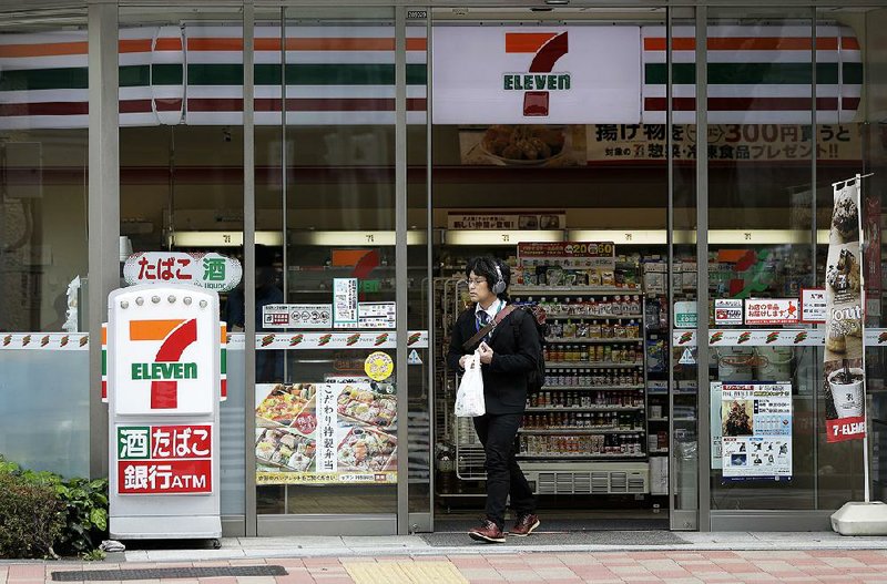 A customer leaves a 7-Eleven convenience store in Tokyo that’s operated by Seven & i Holdings Co. 