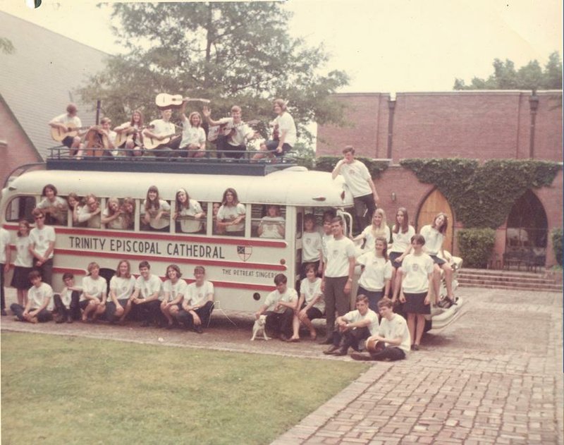 The Retreat Singers are pictured with their fi rst bus, the Holy Roller, in front of Trinity Episcopal Cathedral. In time it would be joined by a second bus dubbed the Exobus, and the group used both to tour the United States and Canada.