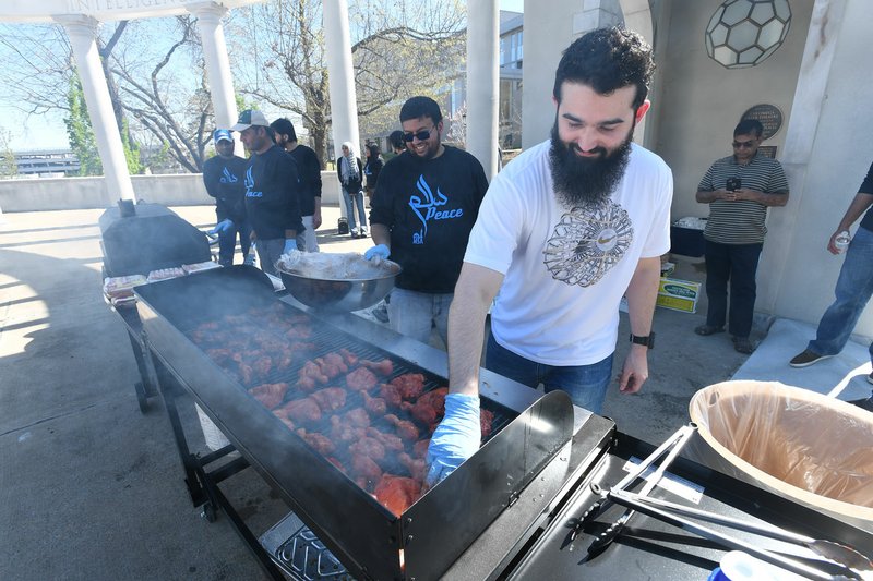 Bilal Ziada of Fayetteville grills chicken at the barbecue. Muslims believe God provides the needs of the body — “food, shelter, clothing, the ability to swallow and digest food …,” said Sheik Fahad Tasleem, the lead instructor with the Islamic Education and Research Academy in Houston, who spoke after the barbecue.