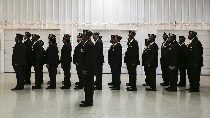 Members of the Michael Vann Johnson Jr. American Legion Post 74 in North Little Rock stand at attention Saturday before the Tribute to Fallen Heroes Ceremony at the Sherwood Forest recreation center in Sherwood. The post was named for an Arkansan who died in Iraq in 2003. 