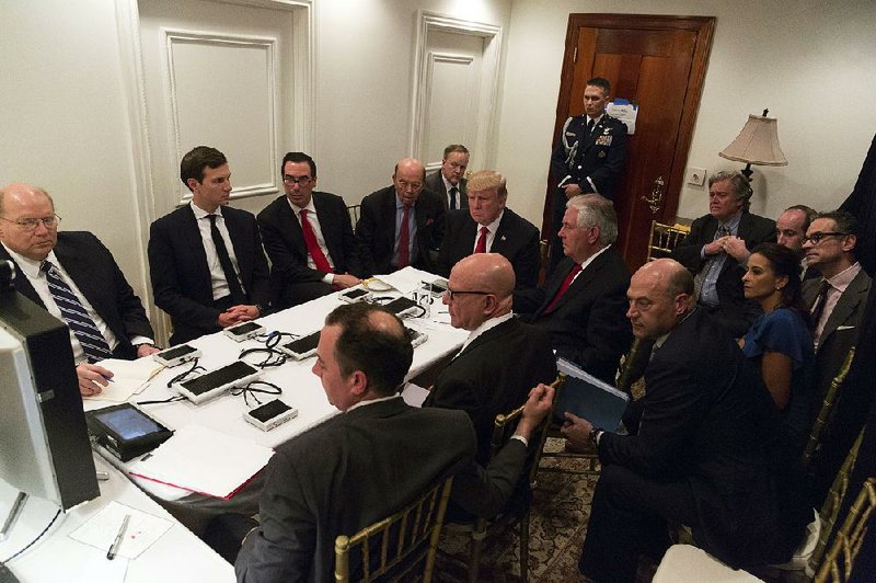 President Donald Trump and some of his Cabinet members and advisers get a briefing about the airstrike on Syria on Thursday at Trump’s Mar-a-Lago resort in Florida, where he was meeting with Chinese President Xi Jinping. Some Chinese analysts said they saw the events as no coincidence, while the official Chinese news agency denounced the strike as the act of a weakened politician.