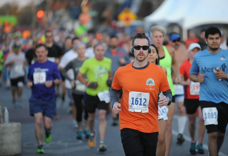 Runners make their way east on Emma Avenue on Saturday after the start of the 41st Hogeye Marathon, Half Marathon, 5K and Relays in downtown Springdale. Visit nwadg.com/photos to see more photographs from the race.